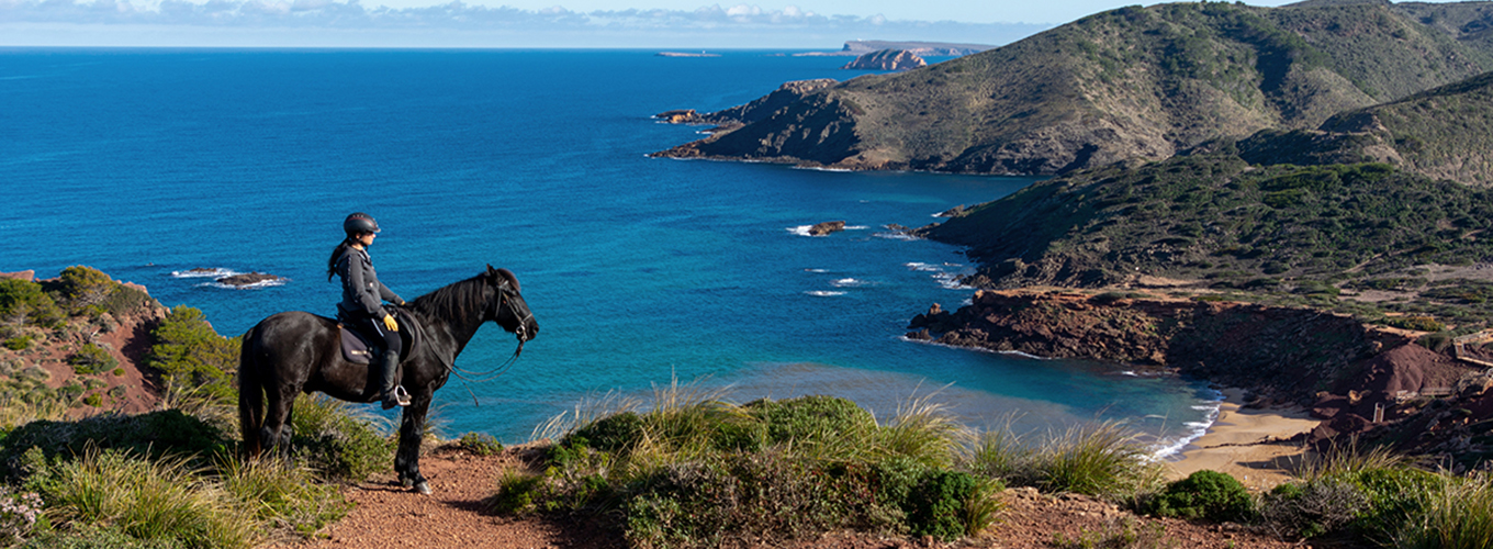 Horse riding along the coast in Menorca island